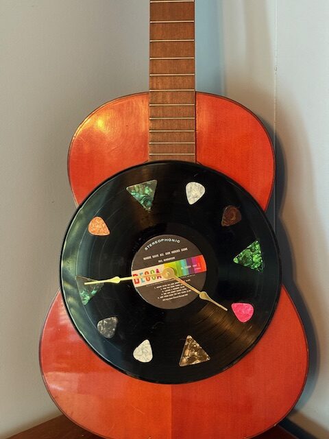RED ACCOUSTIC GUITAR WITH A 33 RPM RECORD